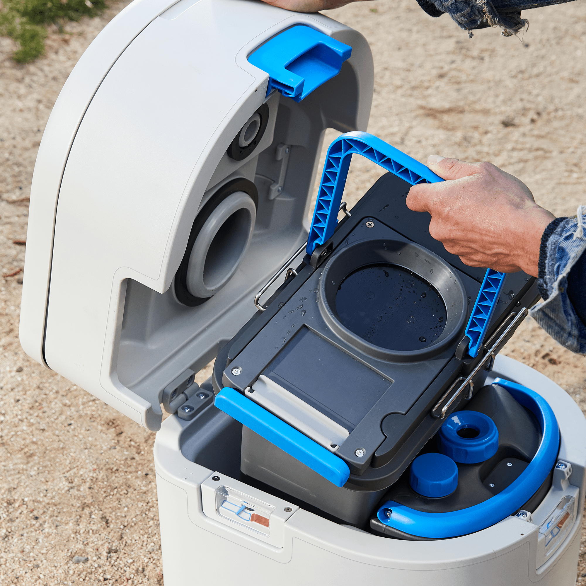 GottaGo portable toilet open showing removable cassette and blue handles
