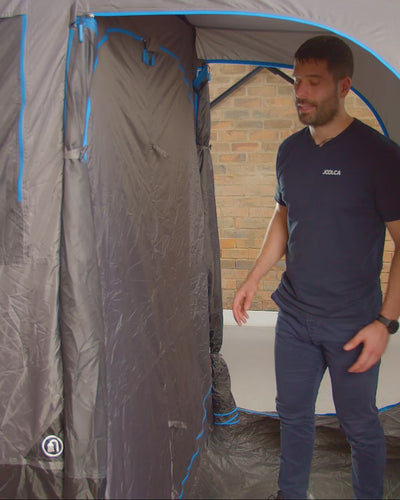 Man opening the internal rooms of the Joolca Ensuite Triple, showing the silver-coated walls
